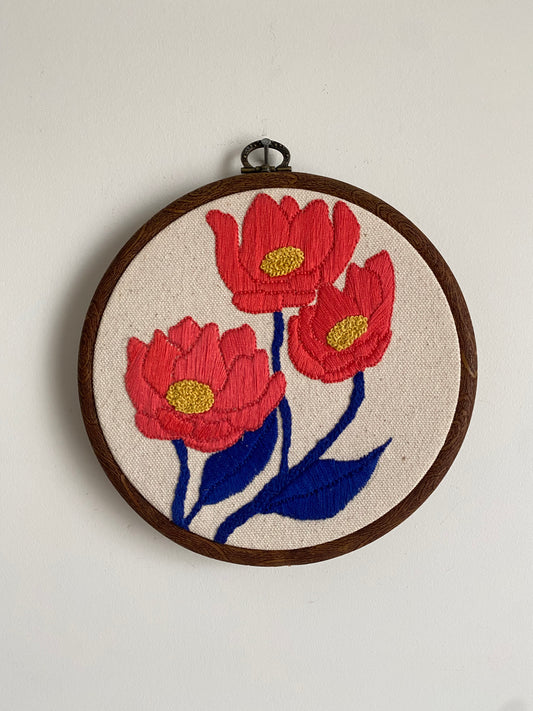 Three embroidered flowers