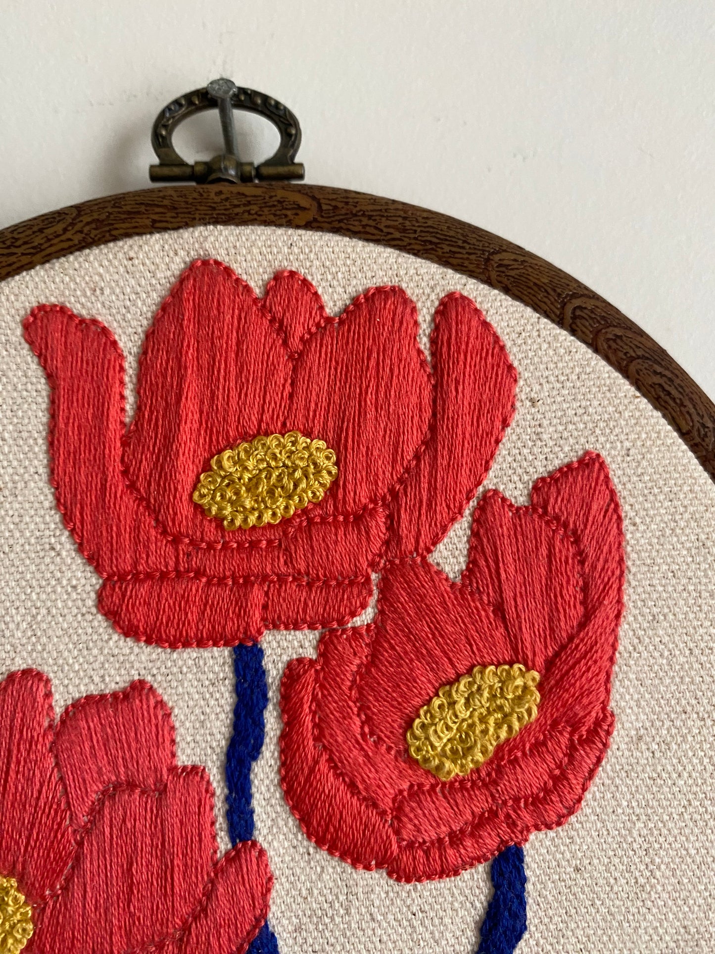 Three embroidered flowers